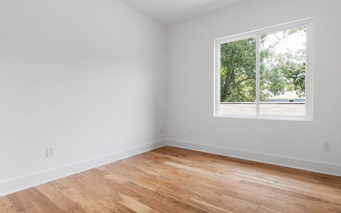 freshly painted white bedroom with large window